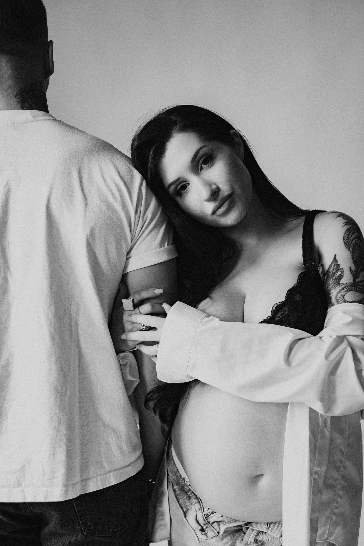 Black and white photo series showing artistic cropped portraits in moody lighting with white clothing.