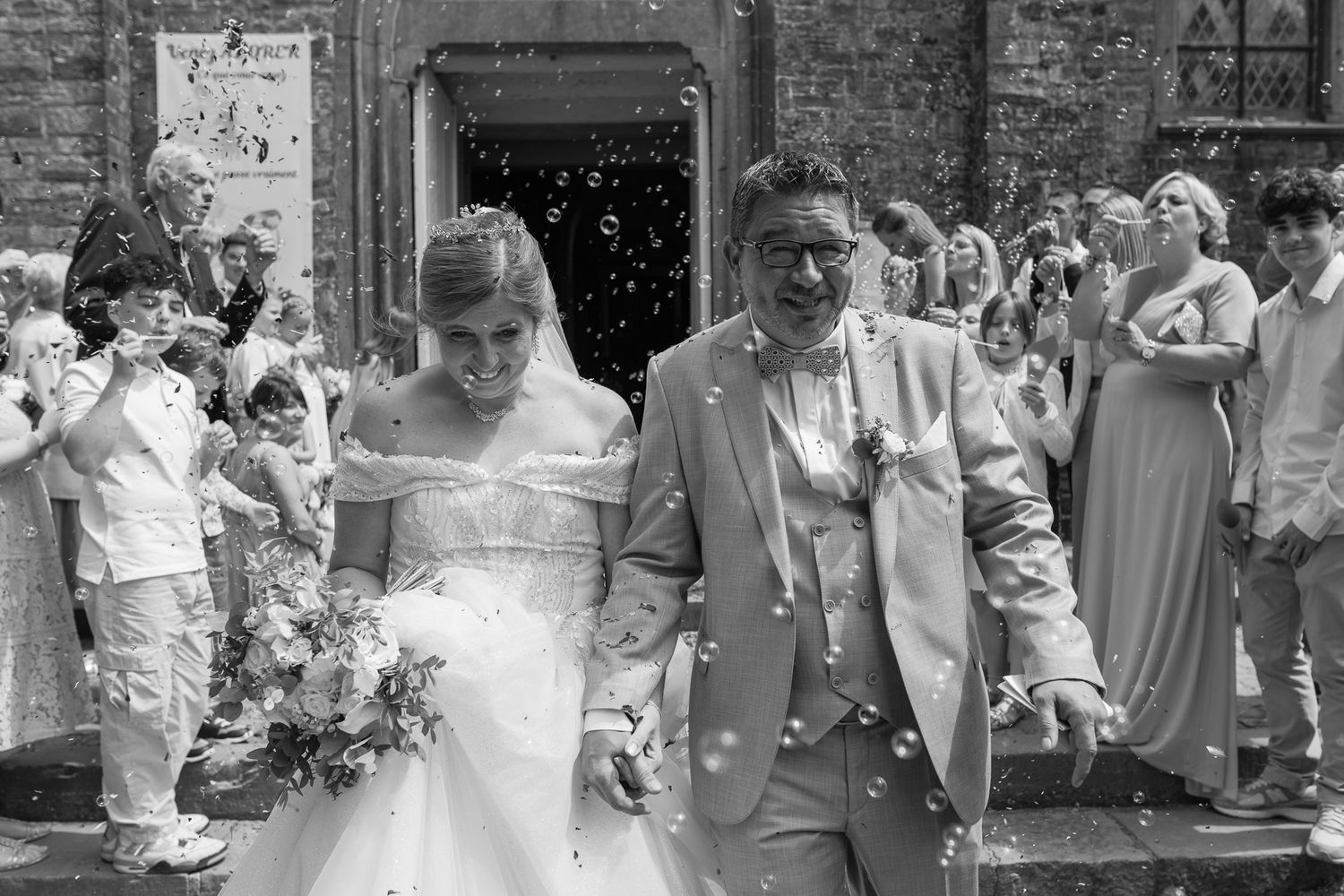 A collection of black and white wedding photographs showing special moments with couples and guests at various ceremonies.