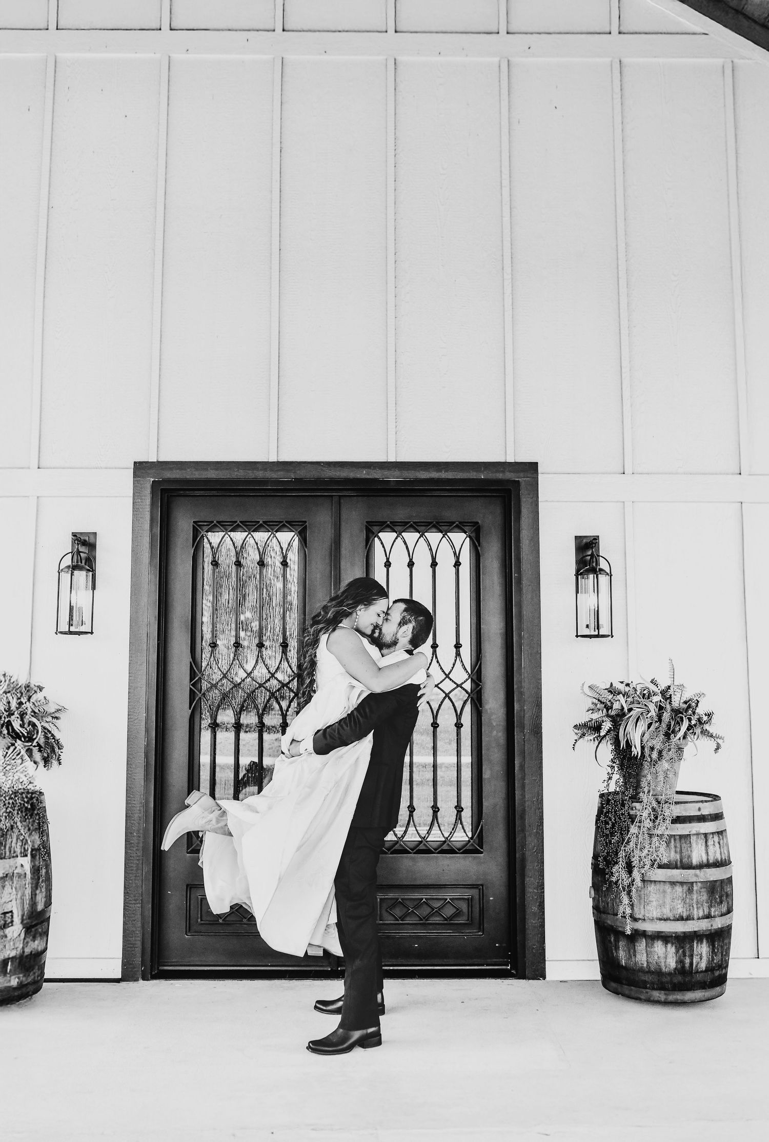 Bride and groom posed for formal photo with North Texas wedding venue backdrop