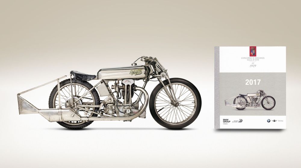Vintage monochrome photograph of a classic Norton motorcycle from the early 1900s with streamlined racing design details.