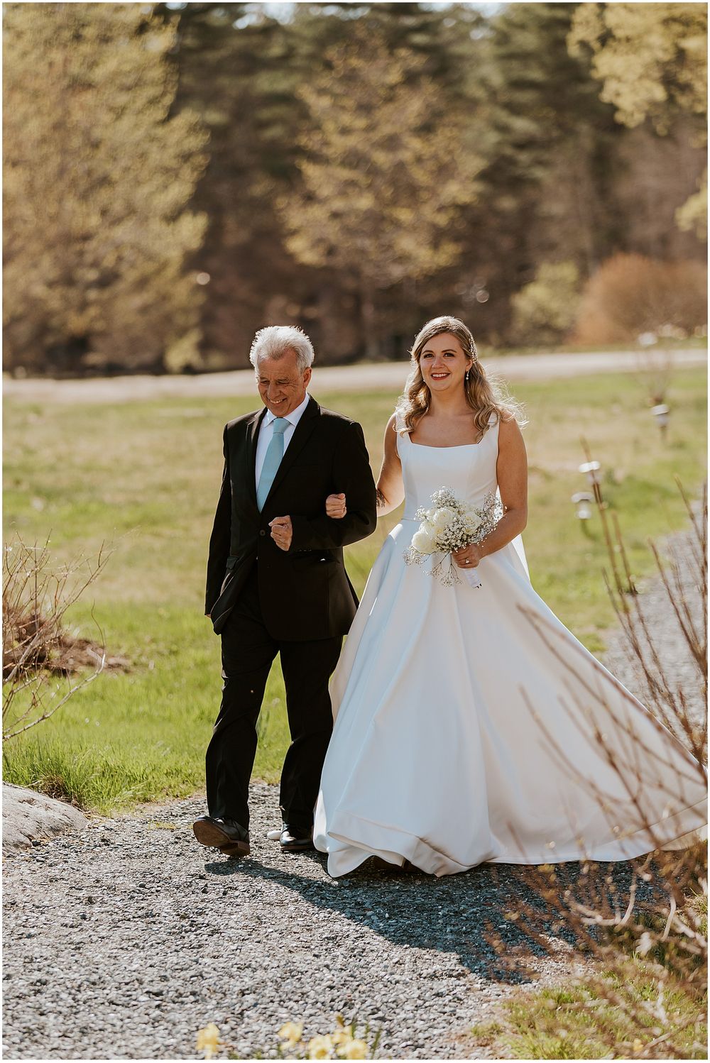 Bride being walked down the aisle by her father at her White Mountain wedding