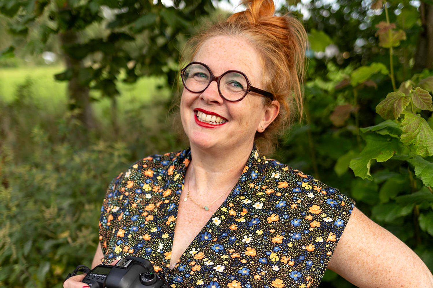 Portretfoto van trouwfotograaf Luzan Veenendaal uit Westzaan. Rode haren, rode lippen zijn haar kenmerken en natuurlijk is ze altijd vrolijk