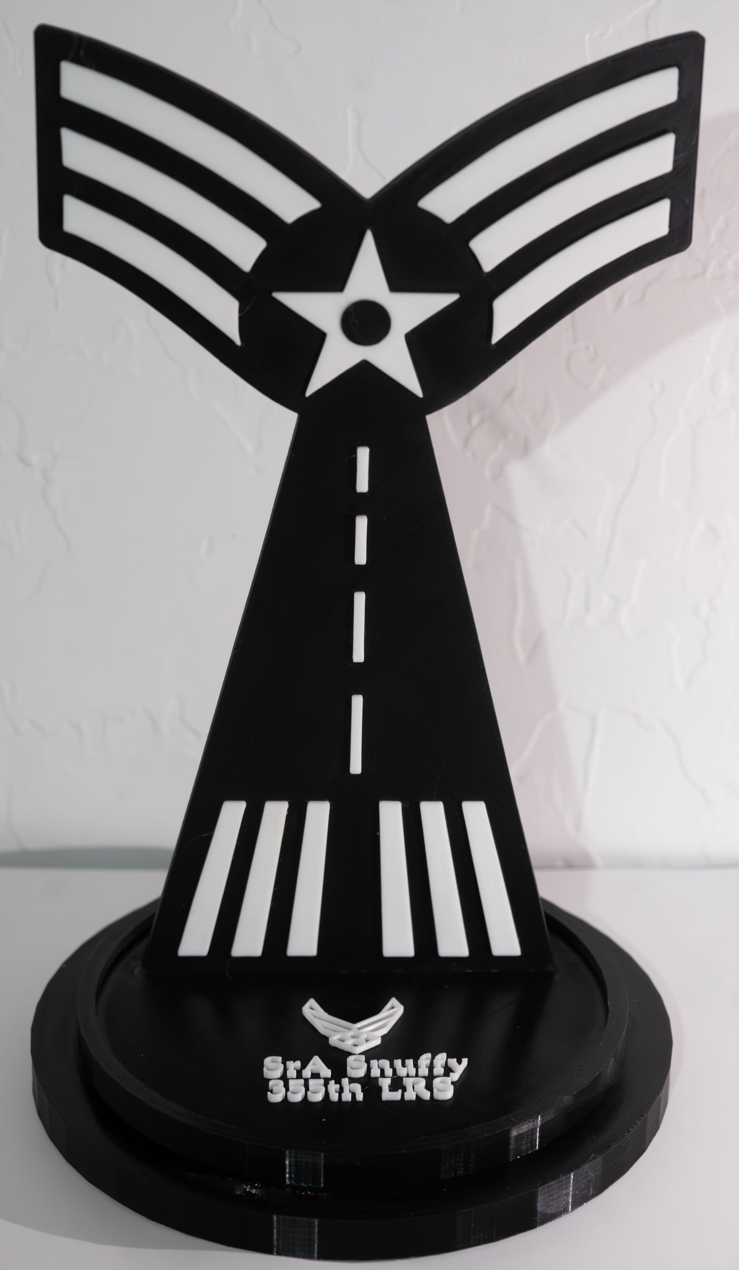 Black decorative military rank insignia trophy displaying runway and chevron design.