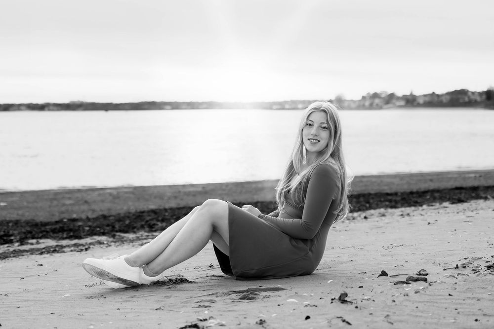 Black and white film strip showing a woman in a swimsuit lounging on a beach in different poses.