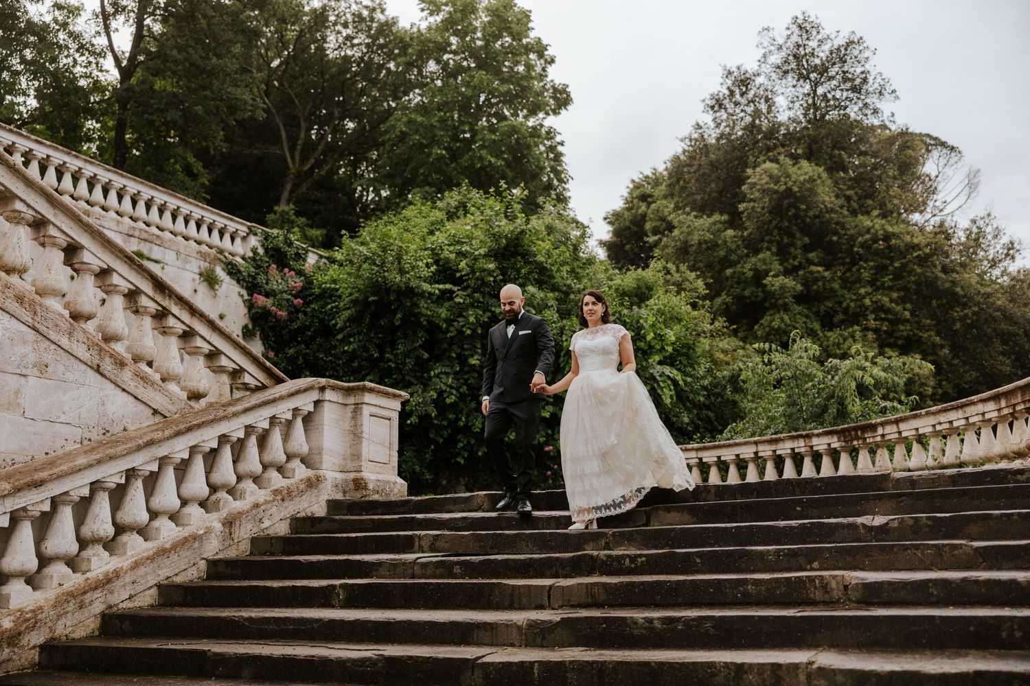 bride and groom walking down steps in Florence, Italy on their elopement day in Tuscany