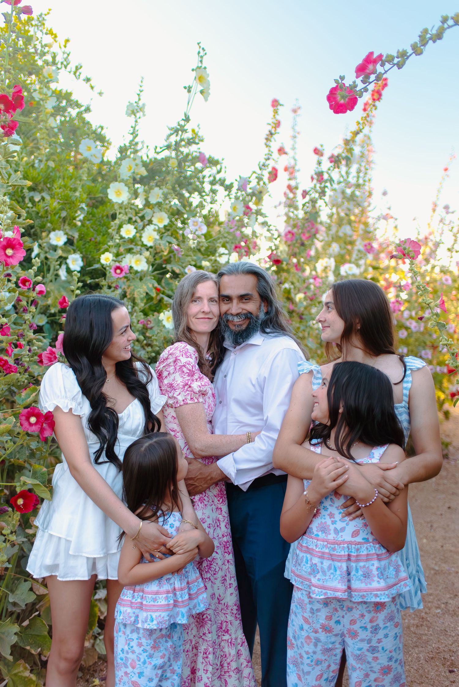Flowering hollyhocks and colorful blooms create a beautiful spring garden in Queen Creek, Arizona.