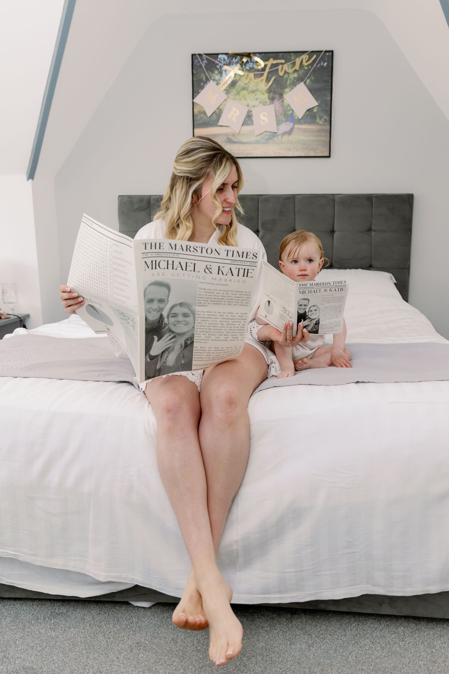 Someone lies on a white couch reading a newspaper in a cozy living room, creating a relaxed weekend atmosphere.