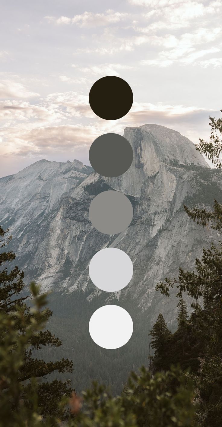Mountain landscape with five grayscale color circles overlaid on Half Dome in Yosemite.