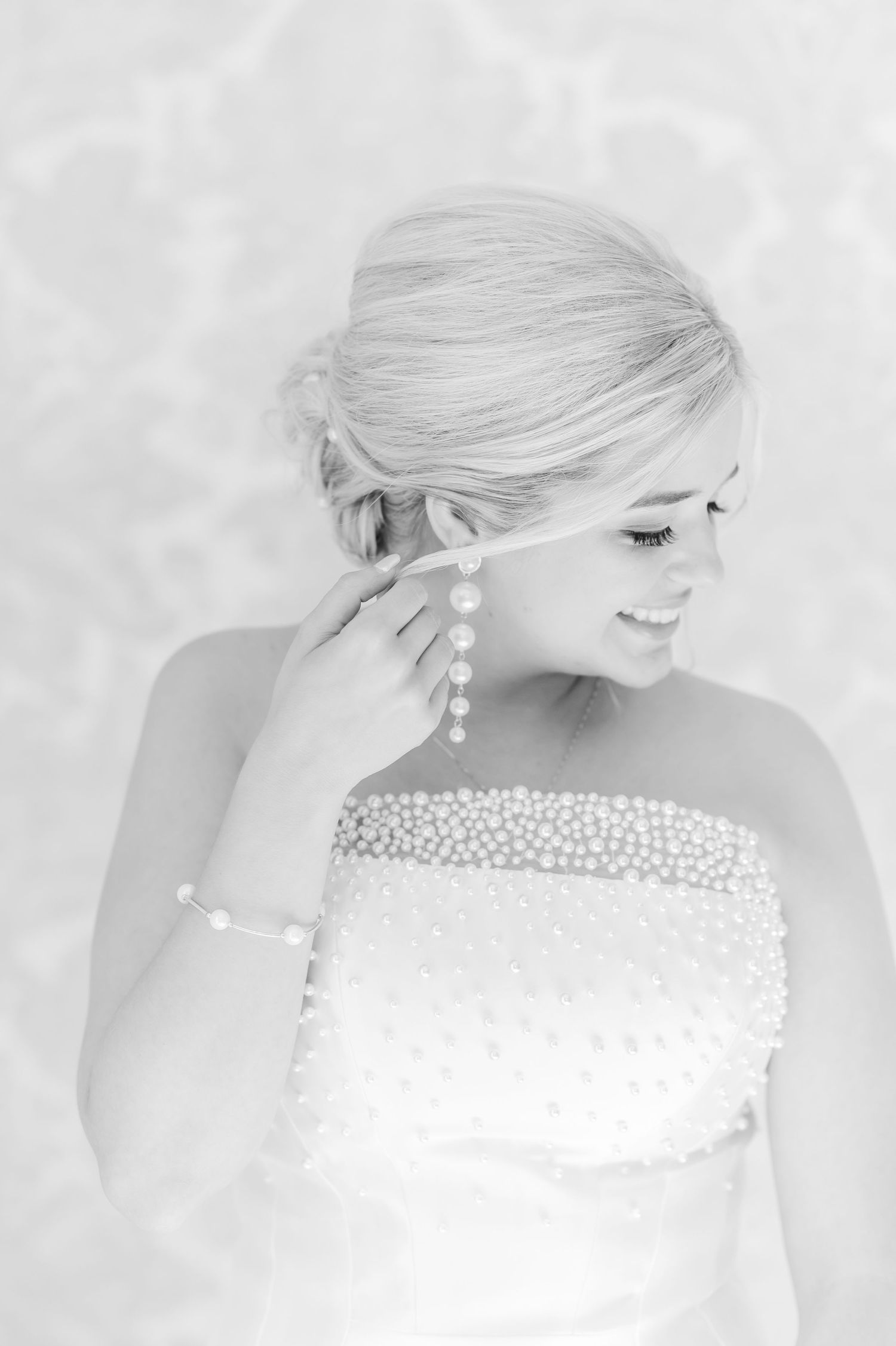 Black and White Bride showing off her earings and bracelet jewelry