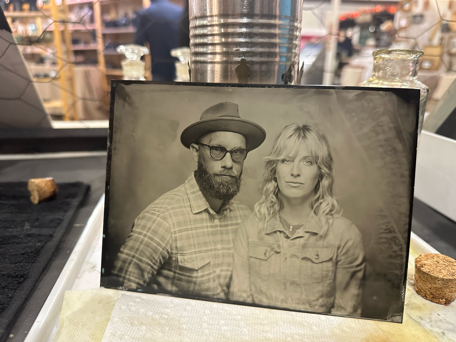 tintype portrait of couple. man wearing a hat