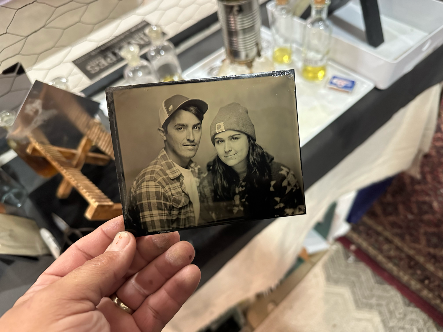 hand holding tintype of young couple