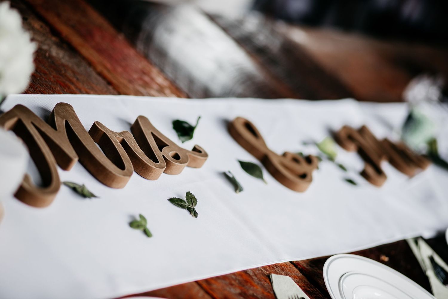 Close-up view of handwritten cursive text in brown ink on white paper with small decorative elements.