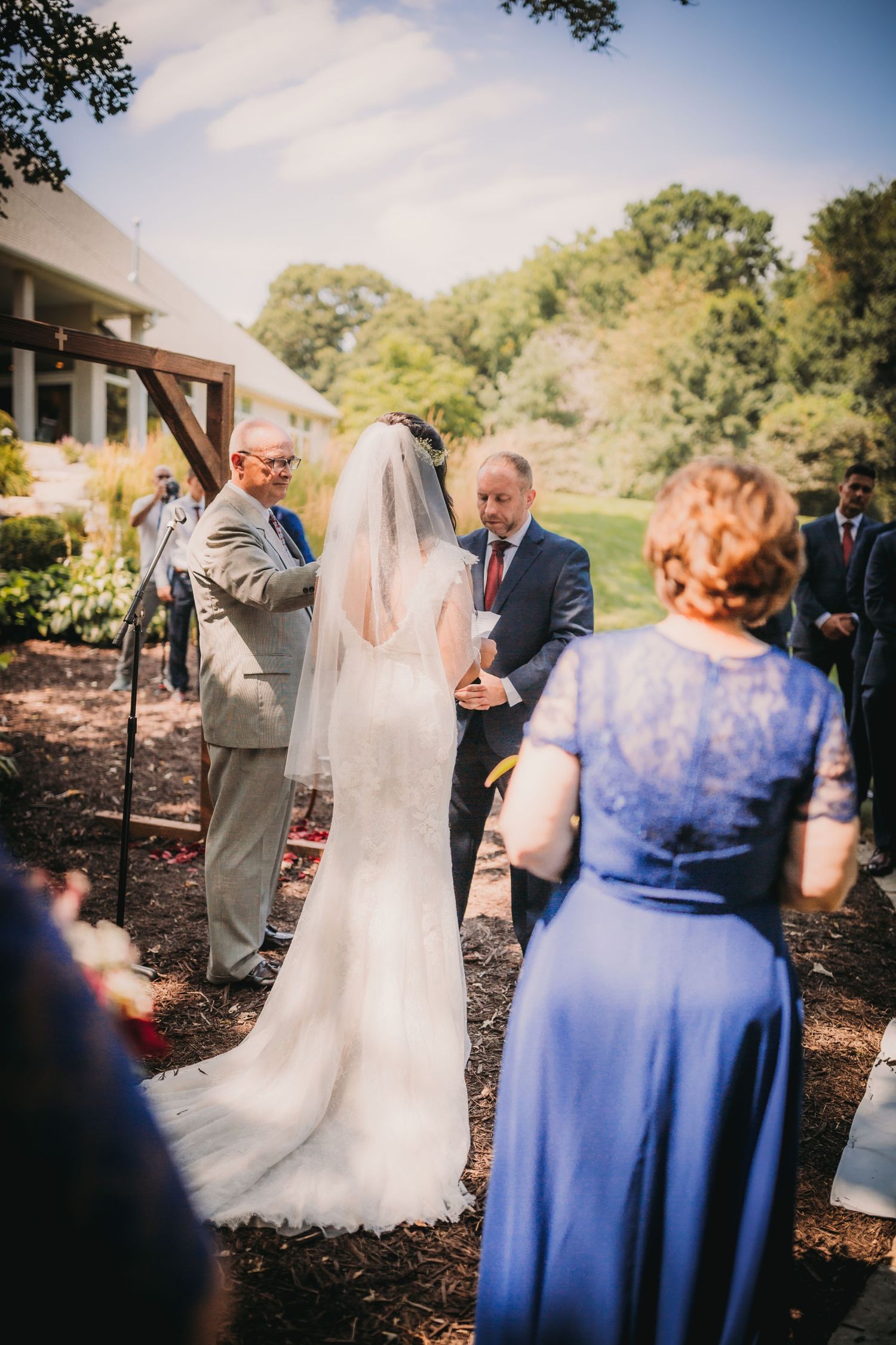 Intimate wedding ceremony moment captured in natural outdoor lighting.