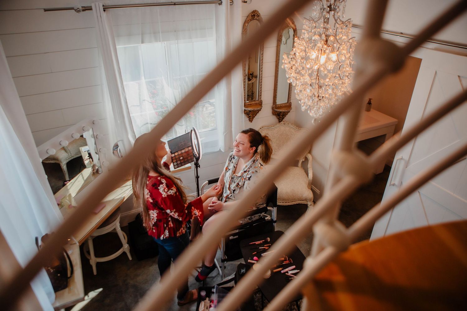 Wedding preparation scene in an elegant white room with vintage decor.
