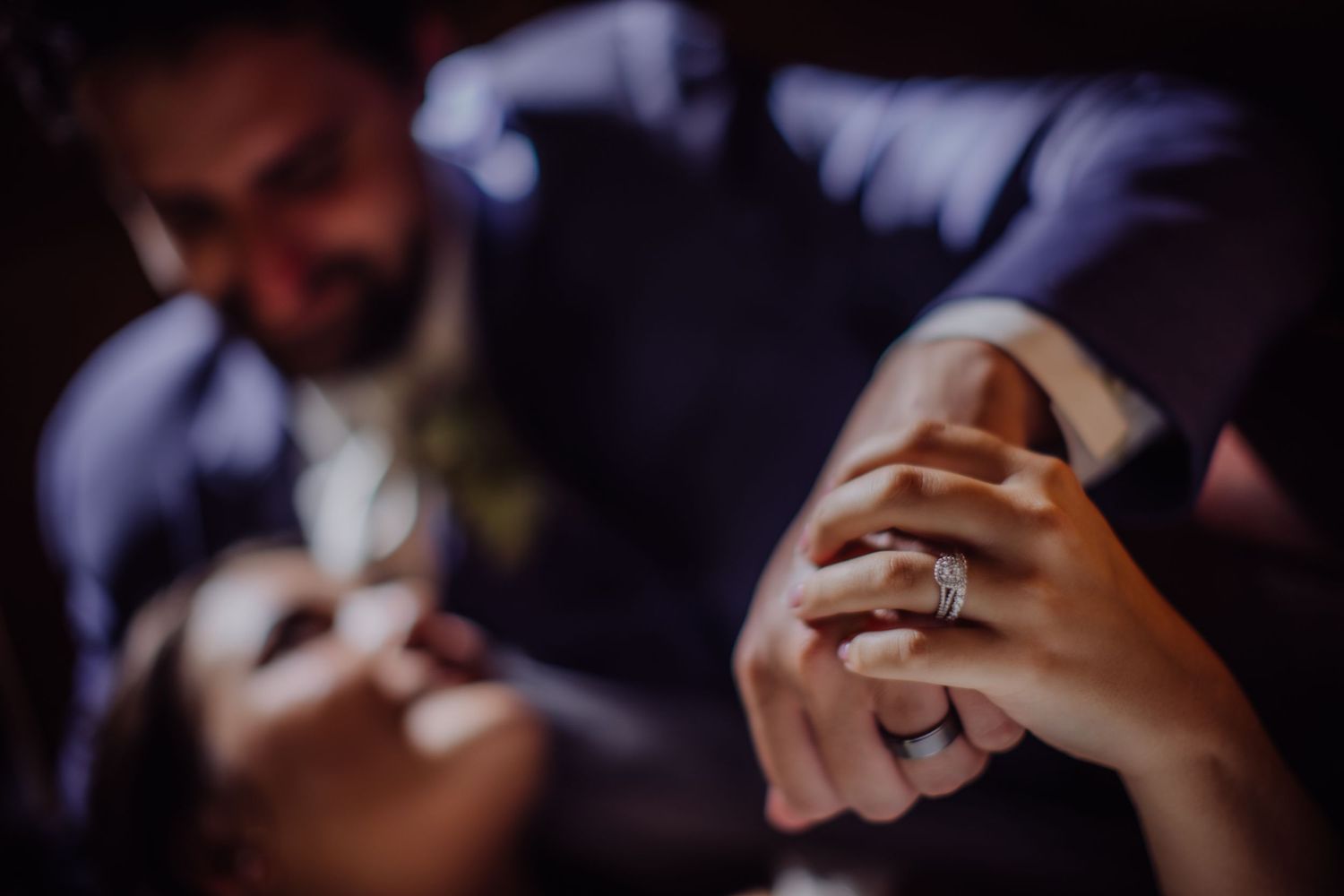 Romantic wedding moment captured in dark, cinematic style.