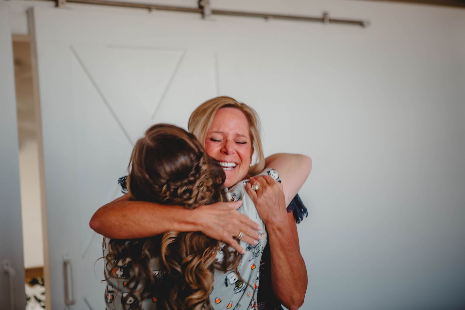 Tender moment between two people hugging during a wedding first look sequence.