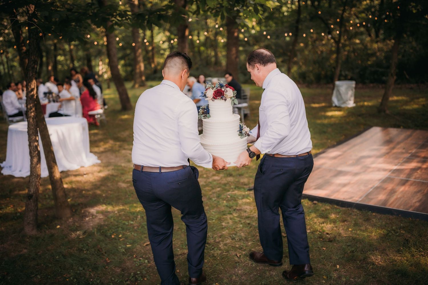 Professional photography lighting equipment set up in a scenic wooded outdoor venue.