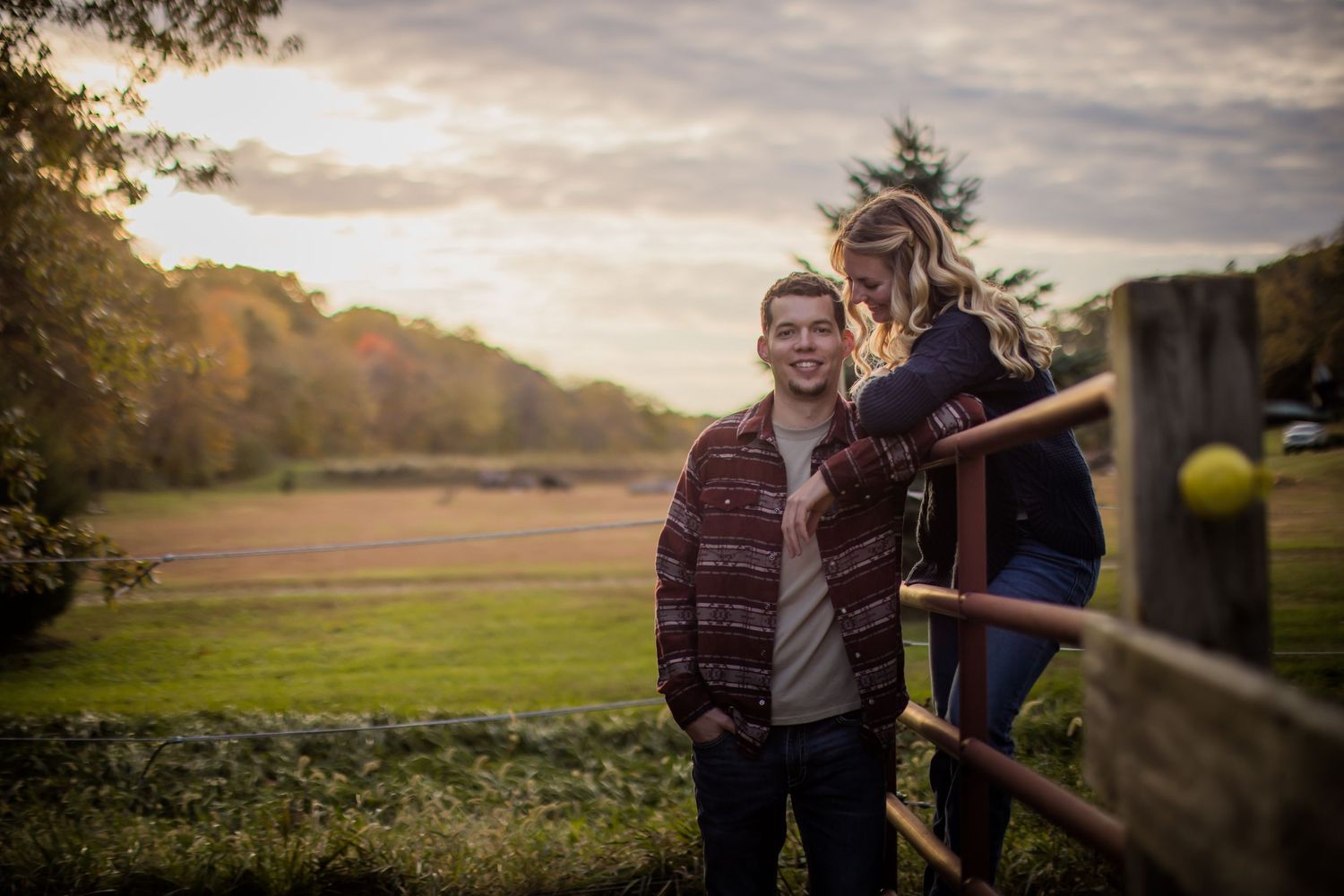 Rural engagement photoshoot with horse in peaceful countryside setting.