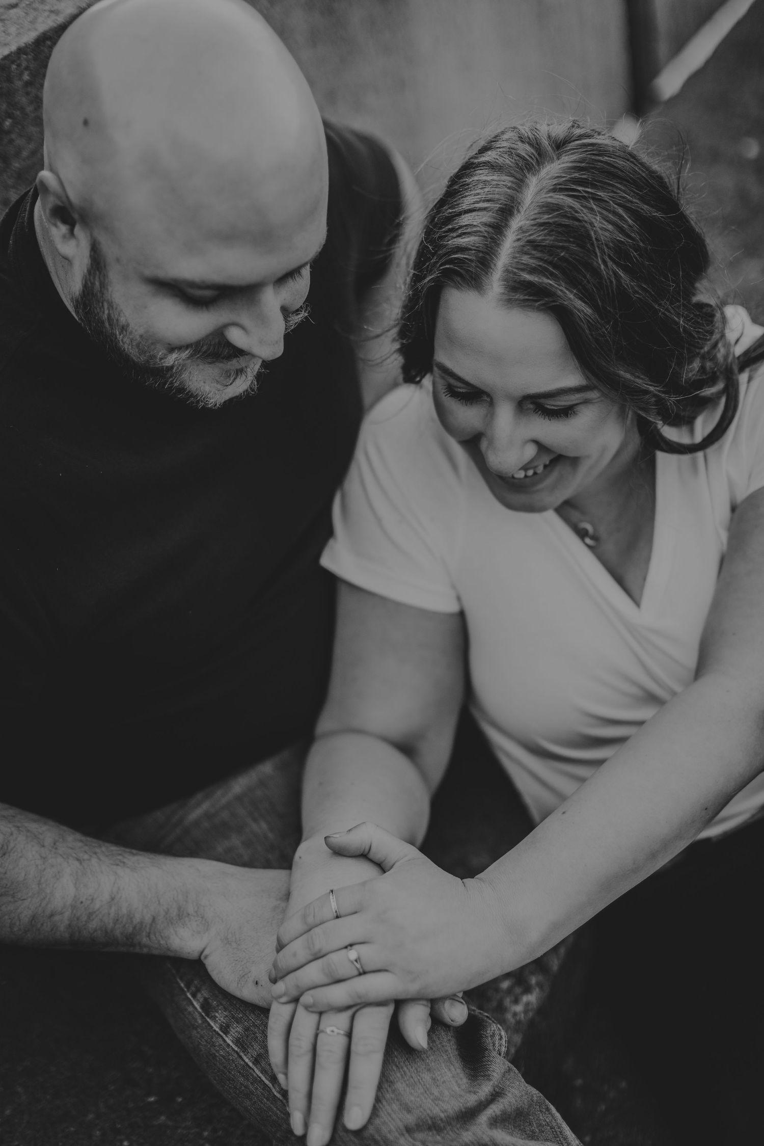 An intimate black and white close-up of a couple sharing a joyful moment together.