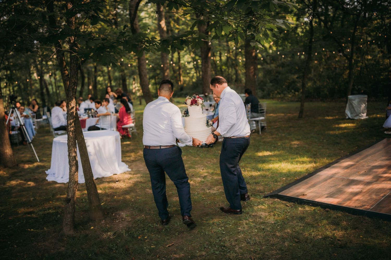 Outdoor photography lighting equipment positioned among trees during a golden hour event.