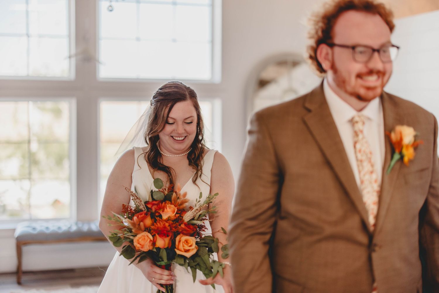A sequence of joyful reactions during a wedding first look in an elegant white room.