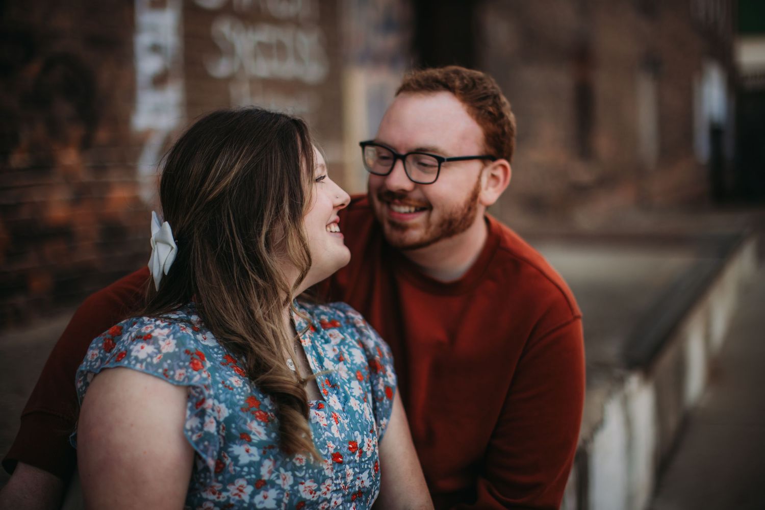 A couple shares a tender moment during their outdoor photoshoot.