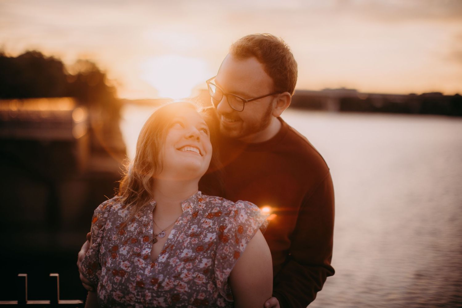 Intimate couple portraits captured during sunset by the waterfront.