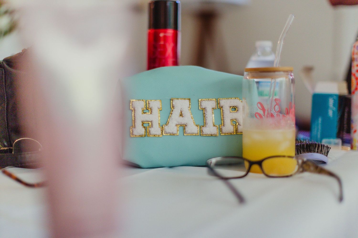 Decorative wedding details and beverages arranged on a table.