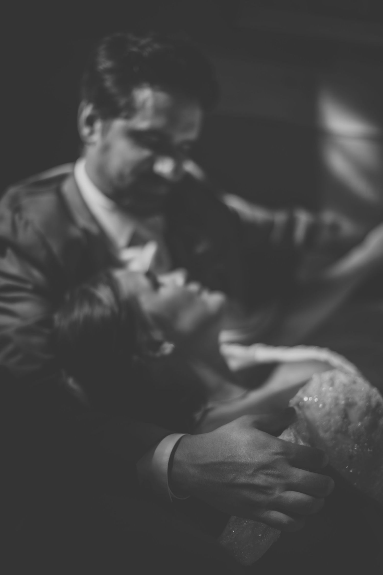 Atmospheric black and white wedding photography with shallow depth of field.