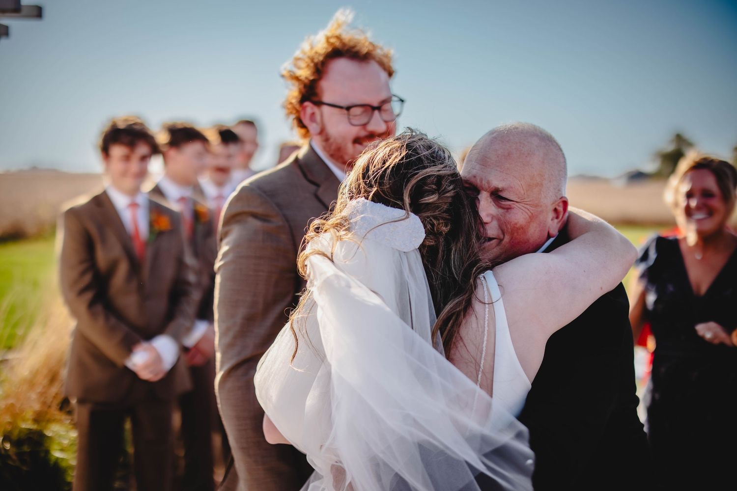 Sunlit outdoor wedding ceremony with beautiful natural landscape backdrop.