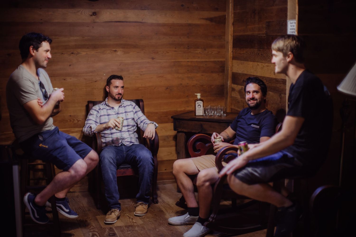 Casual social gathering in a cozy wooden cabin setting.