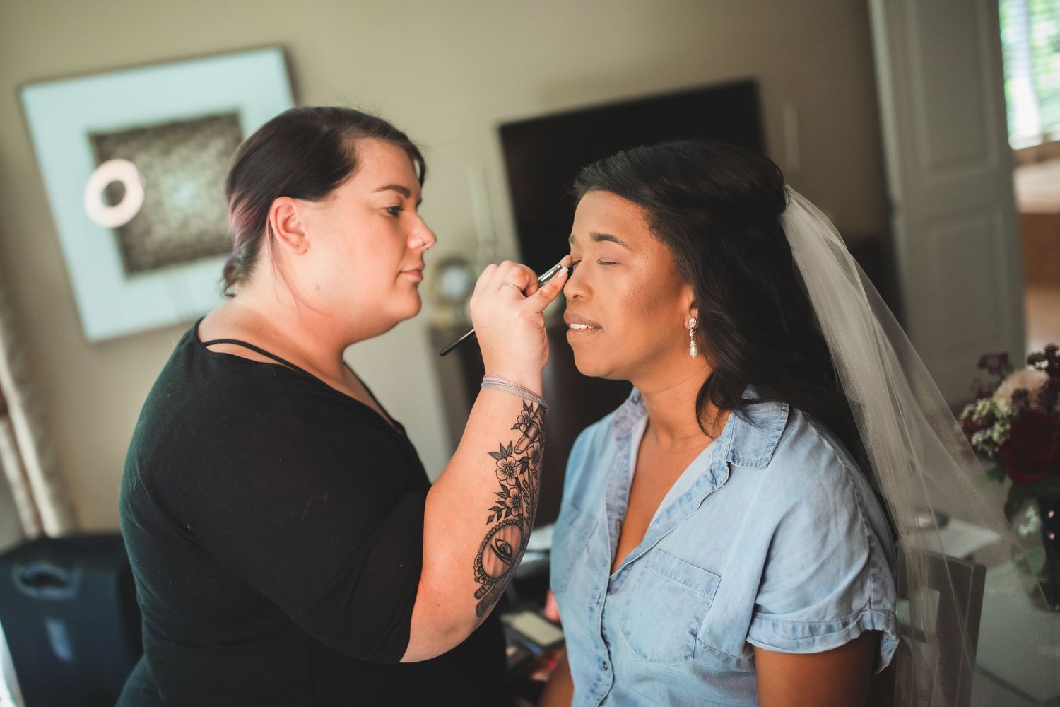 Close-up shot of makeup application during bridal preparation.