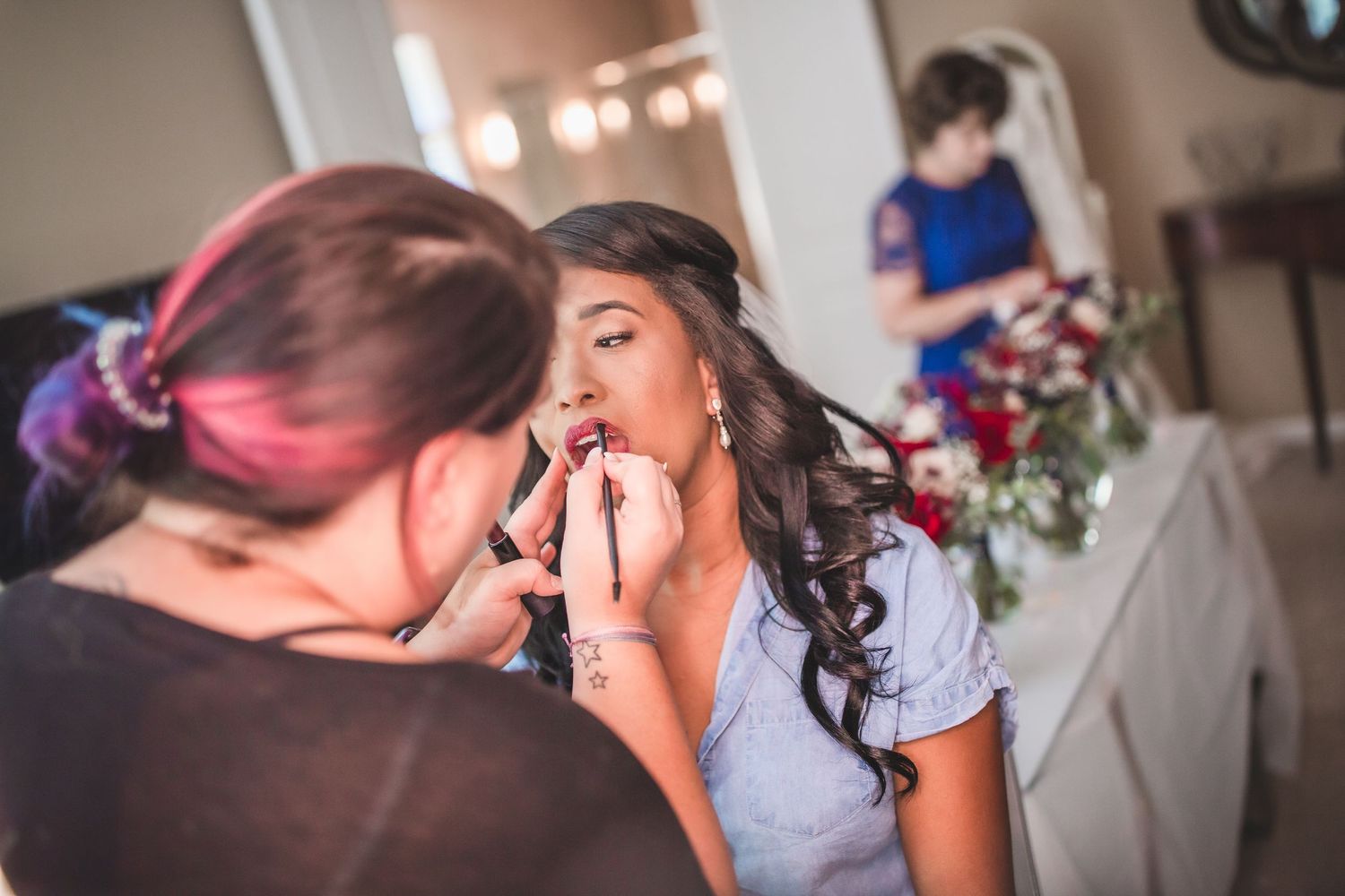 Close-up of makeup application during bridal preparation.
