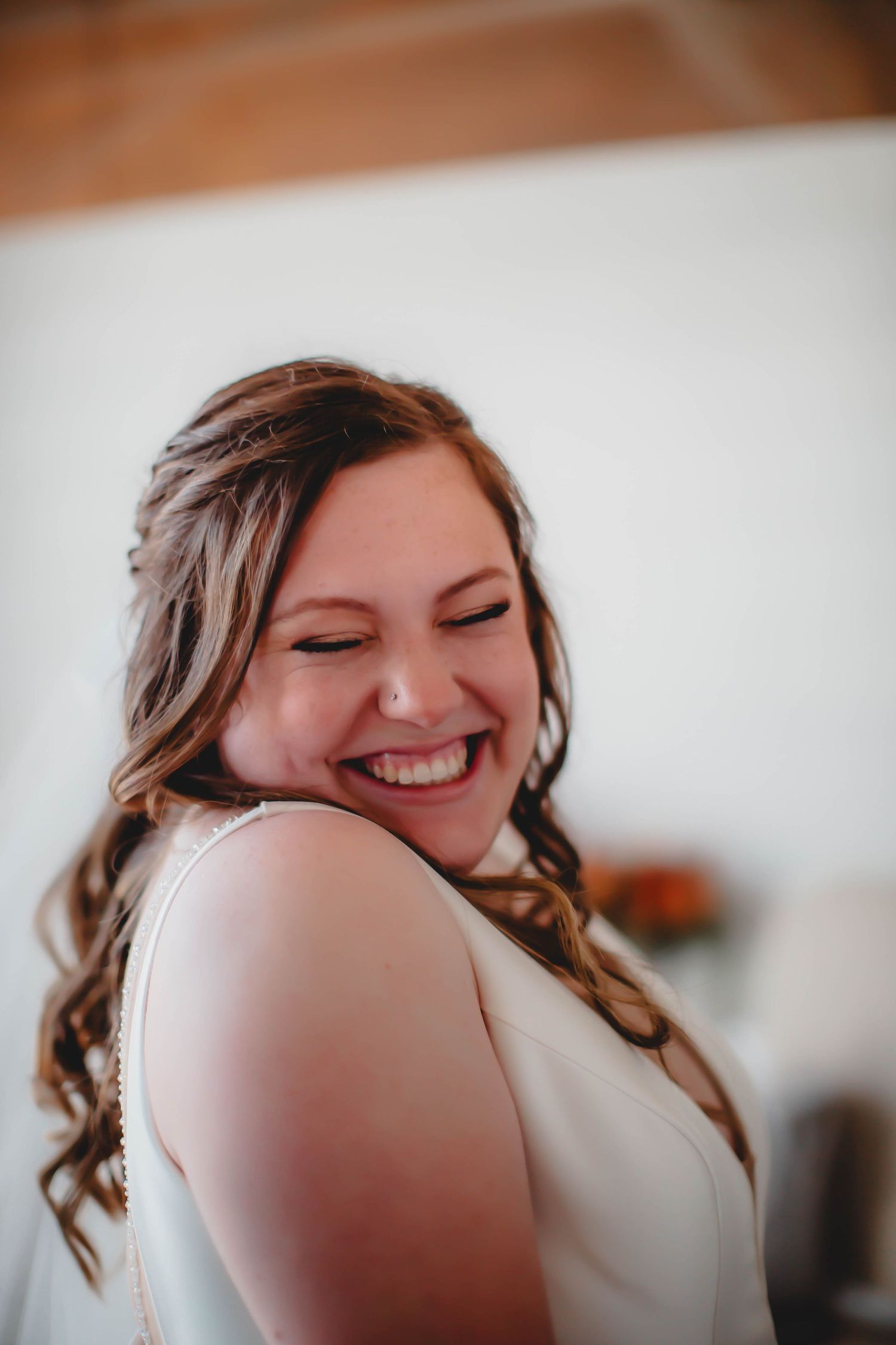 Close up of someone laughing joyfully during wedding celebrations.