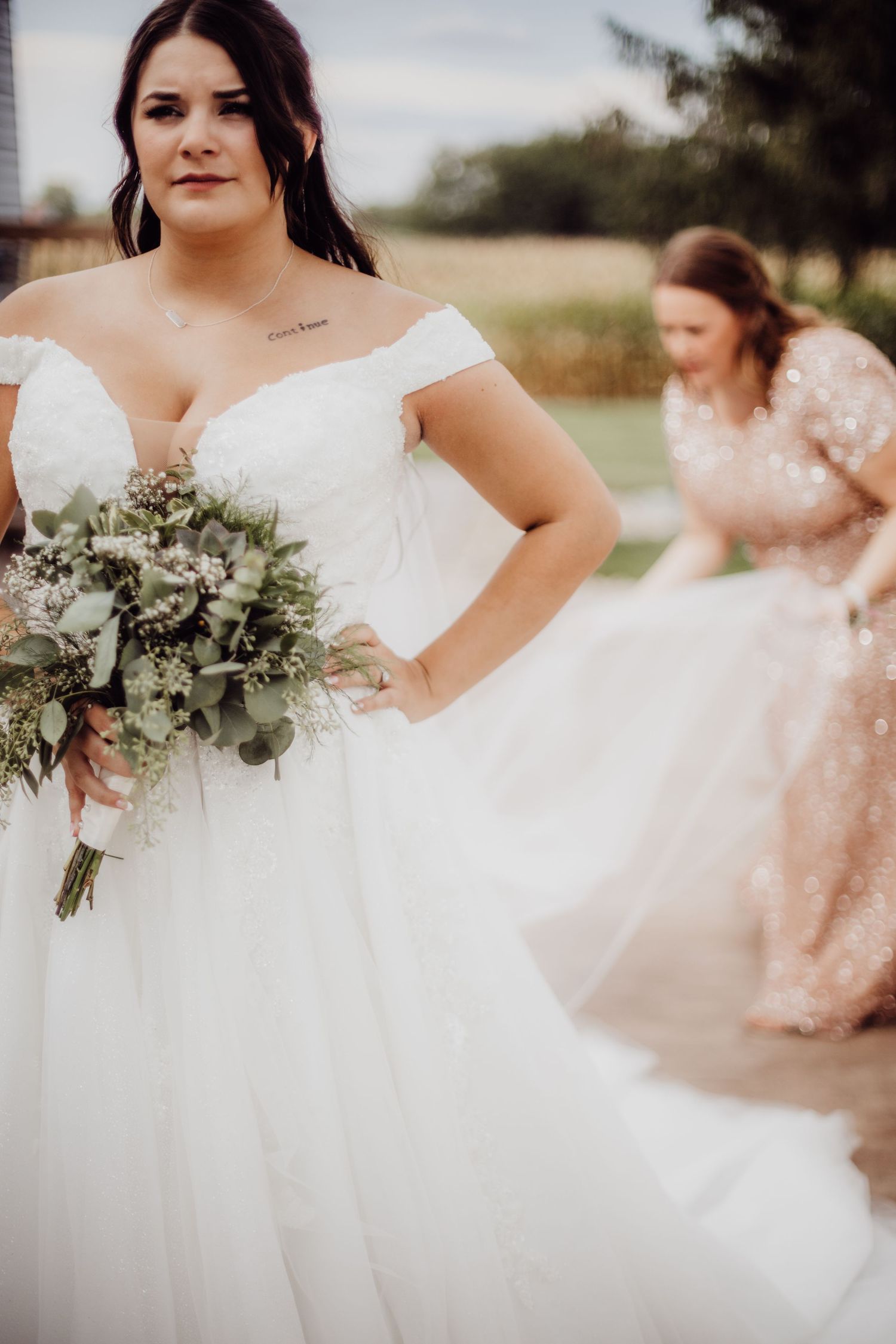 Beautiful bridal portrait showcasing an off-shoulder wedding gown and natural bouquet.