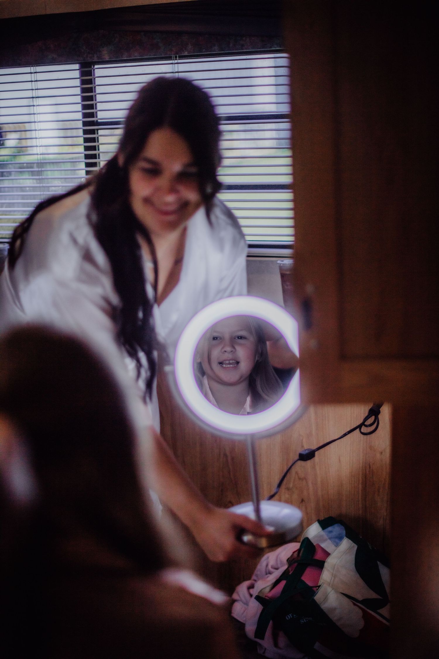A white LED makeup mirror reflects a bright smile during morning preparations.