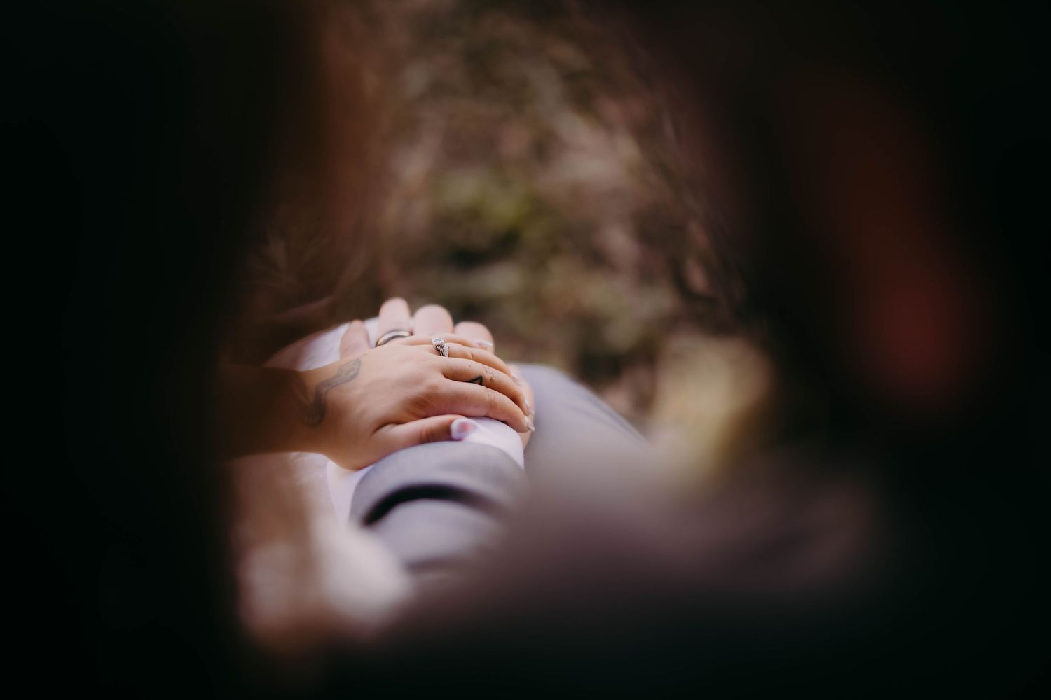 A close-up artistic shot of wedding rings with soft focus and natural lighting.