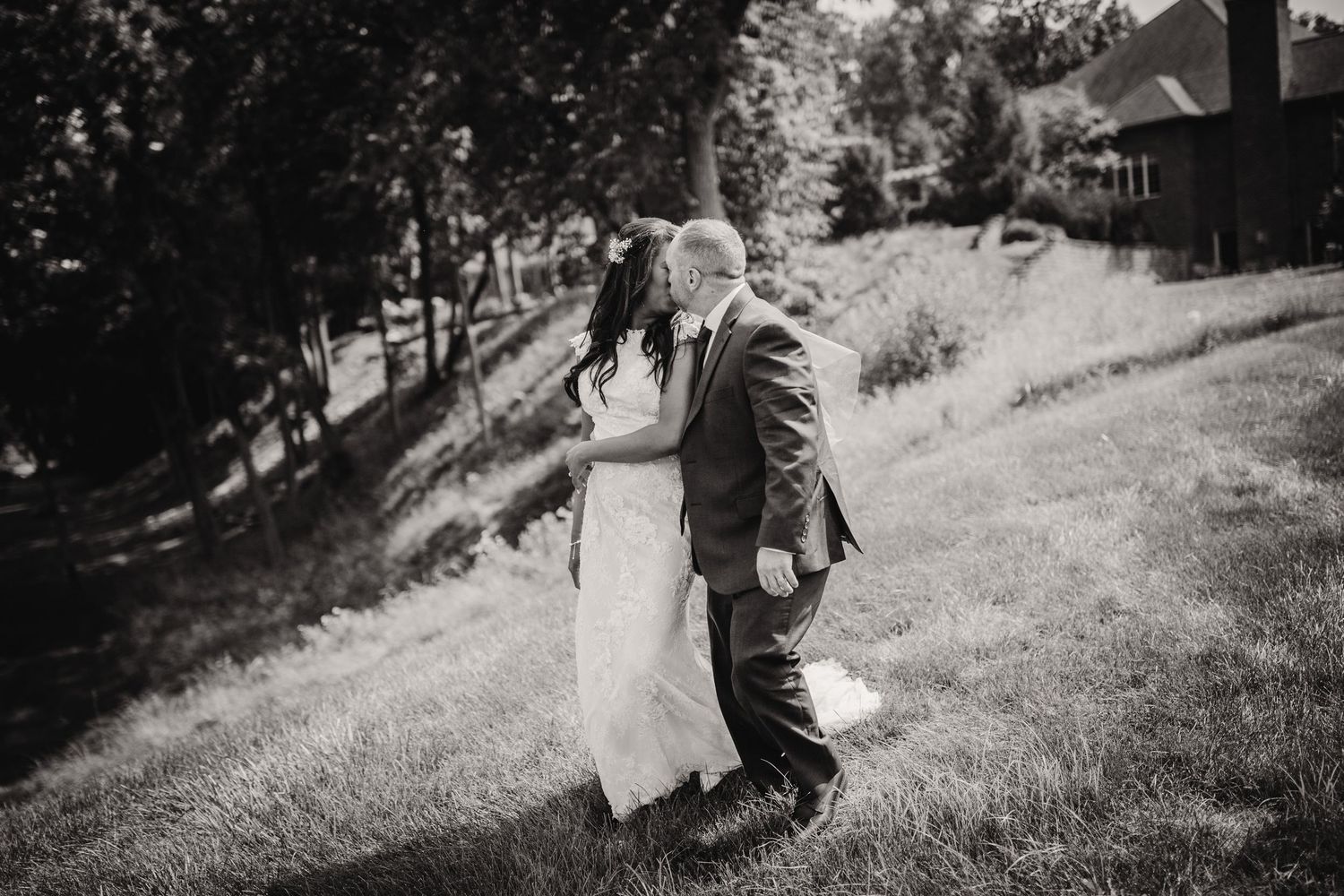 Black and white portrait of a couple walking together on their wedding day.