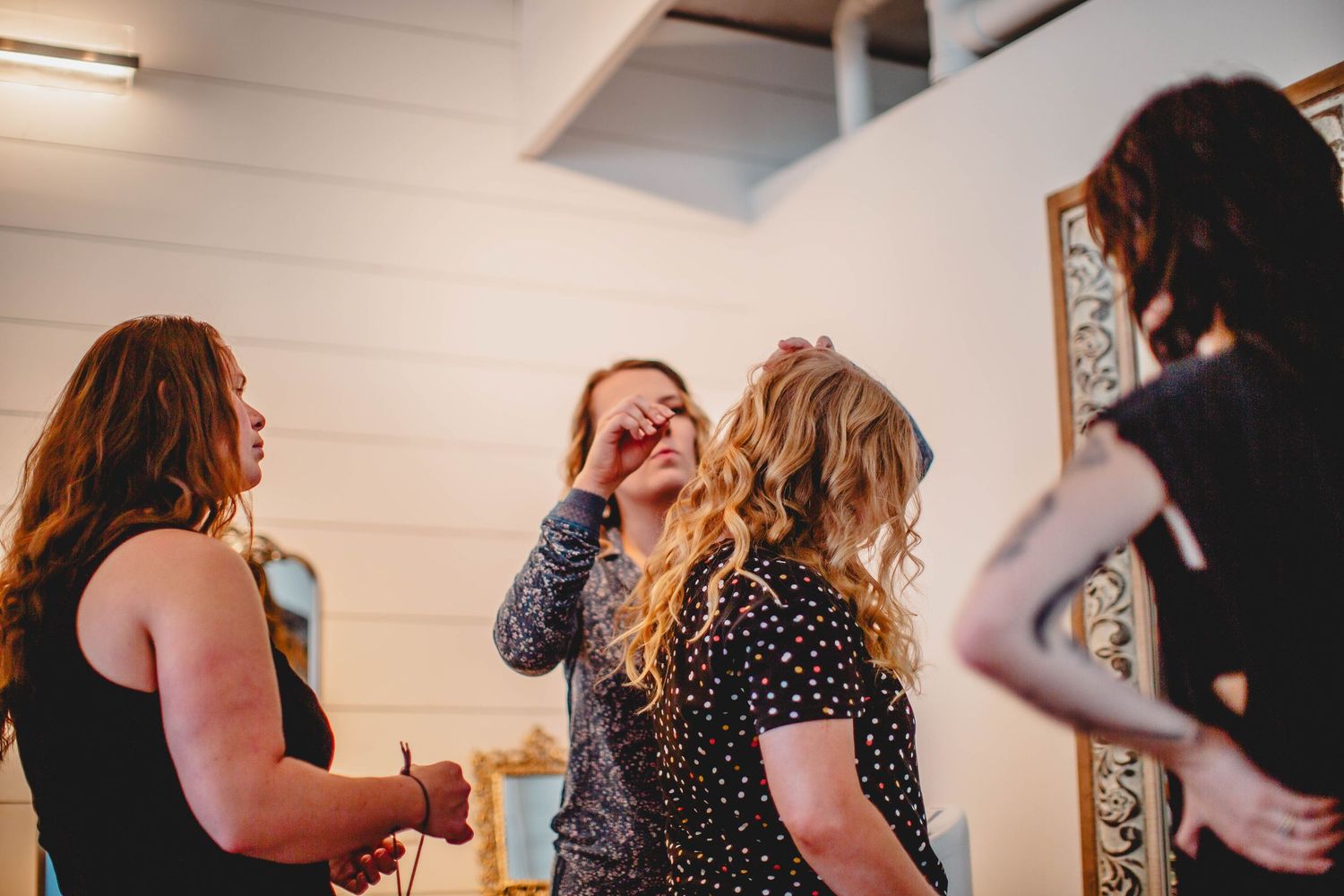 A group laughs together during a joyful moment in a bright indoor setting.