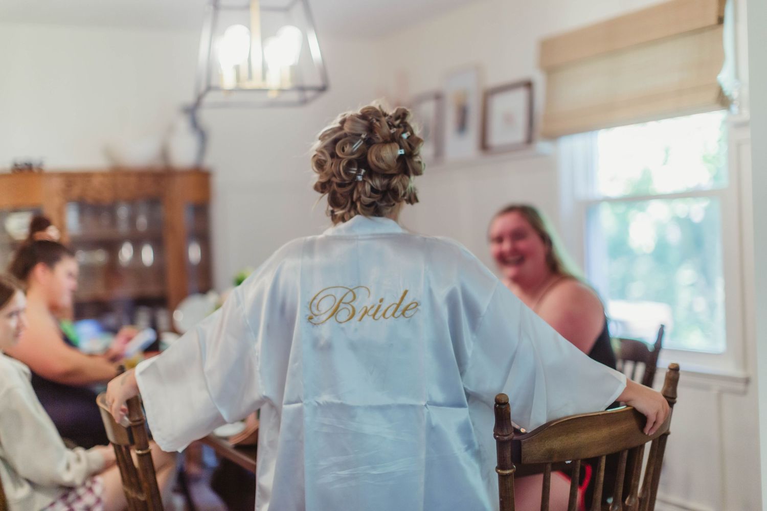 Wedding party members in matching robes during morning preparations.