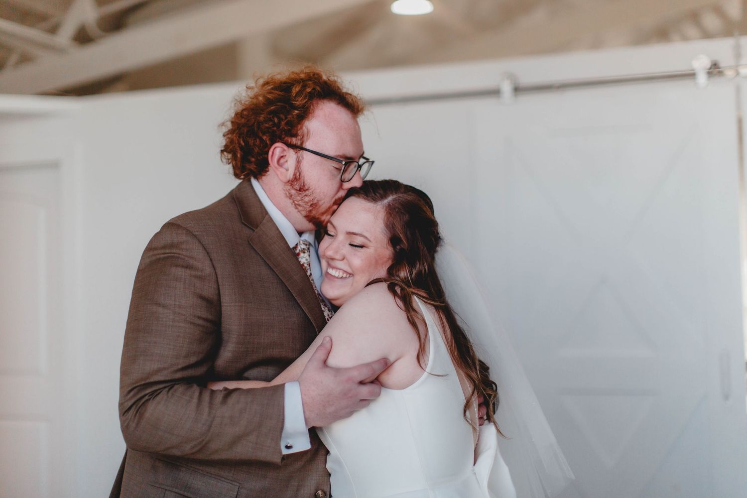 Joyful embrace between newlyweds during intimate wedding moment.