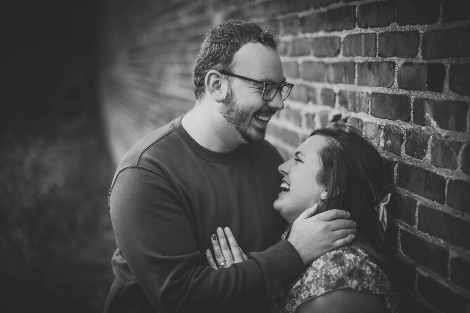 Intimate black and white portrait of a couple sharing a tender moment.