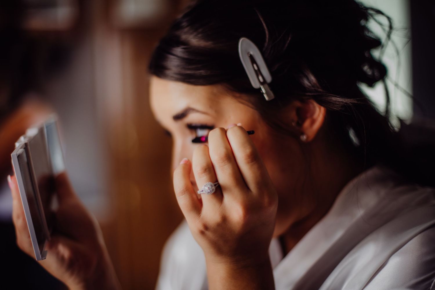Close-up shot of emotional preparations on a wedding morning in natural light.