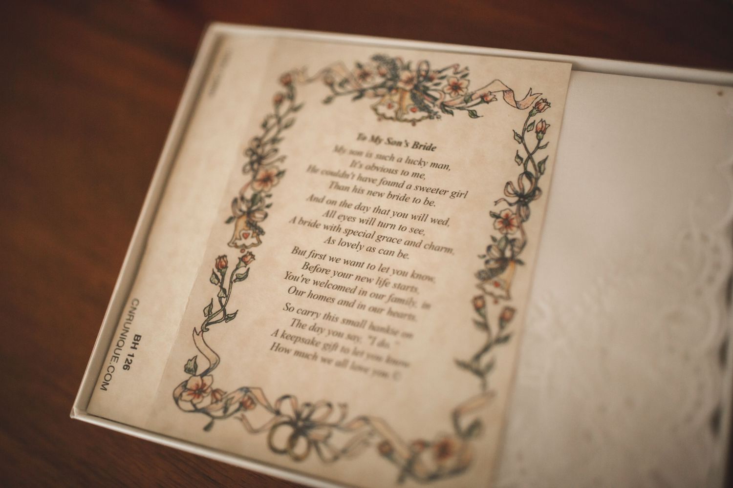 Vintage wedding guest book with delicate floral illustrations and handwritten text.