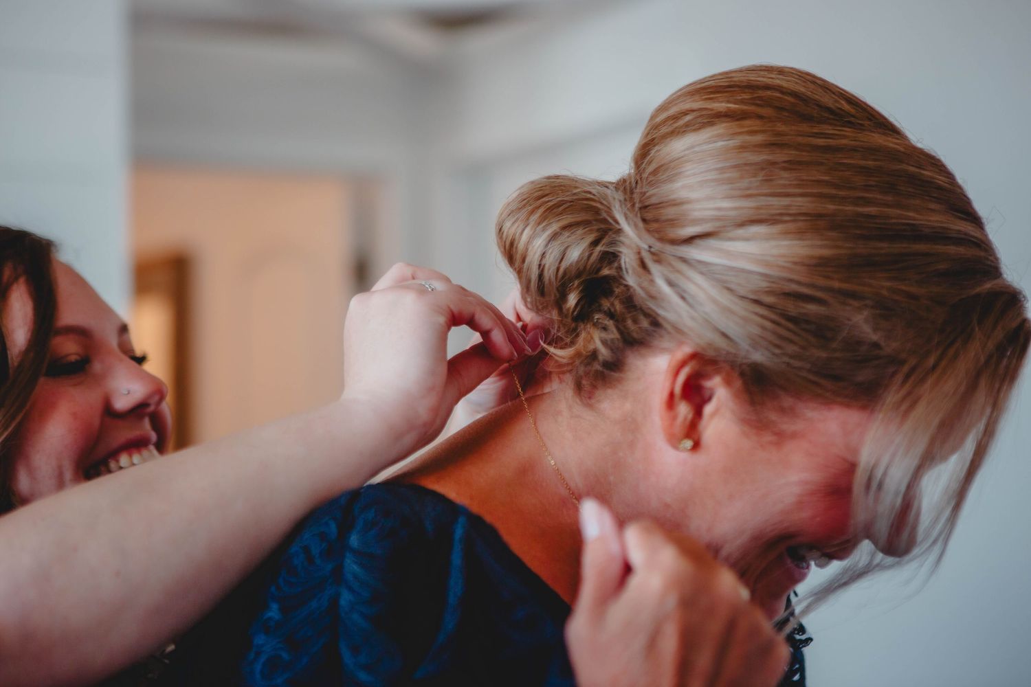 Final touches being added to an elegant updo hairstyle.