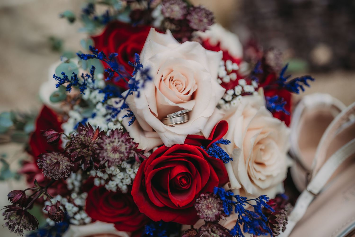 Red, white and blue floral wedding bouquet with roses and baby's breath creates an elegant patriotic color scheme.