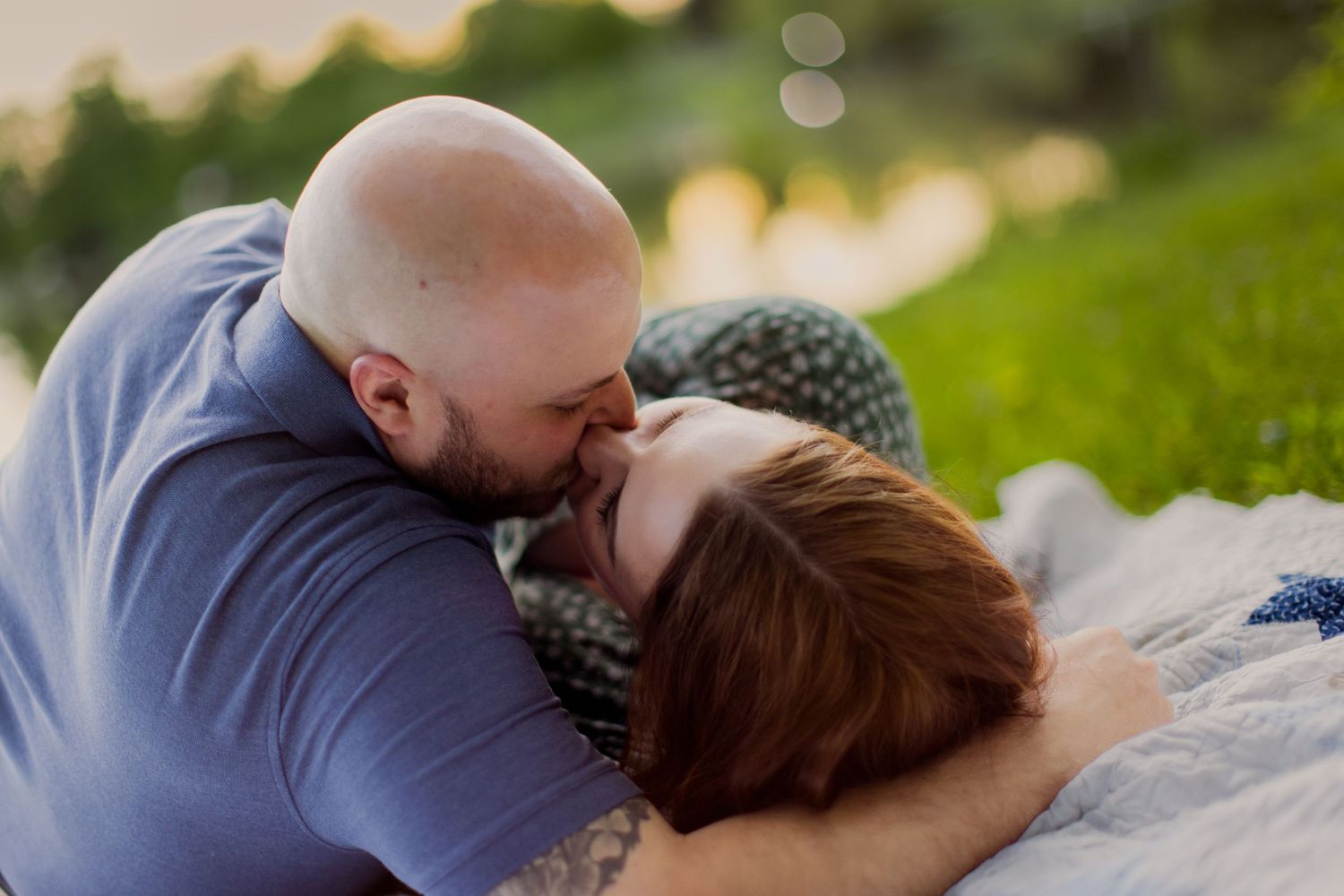Romantic couple photography in a natural setting with sunset lighting.