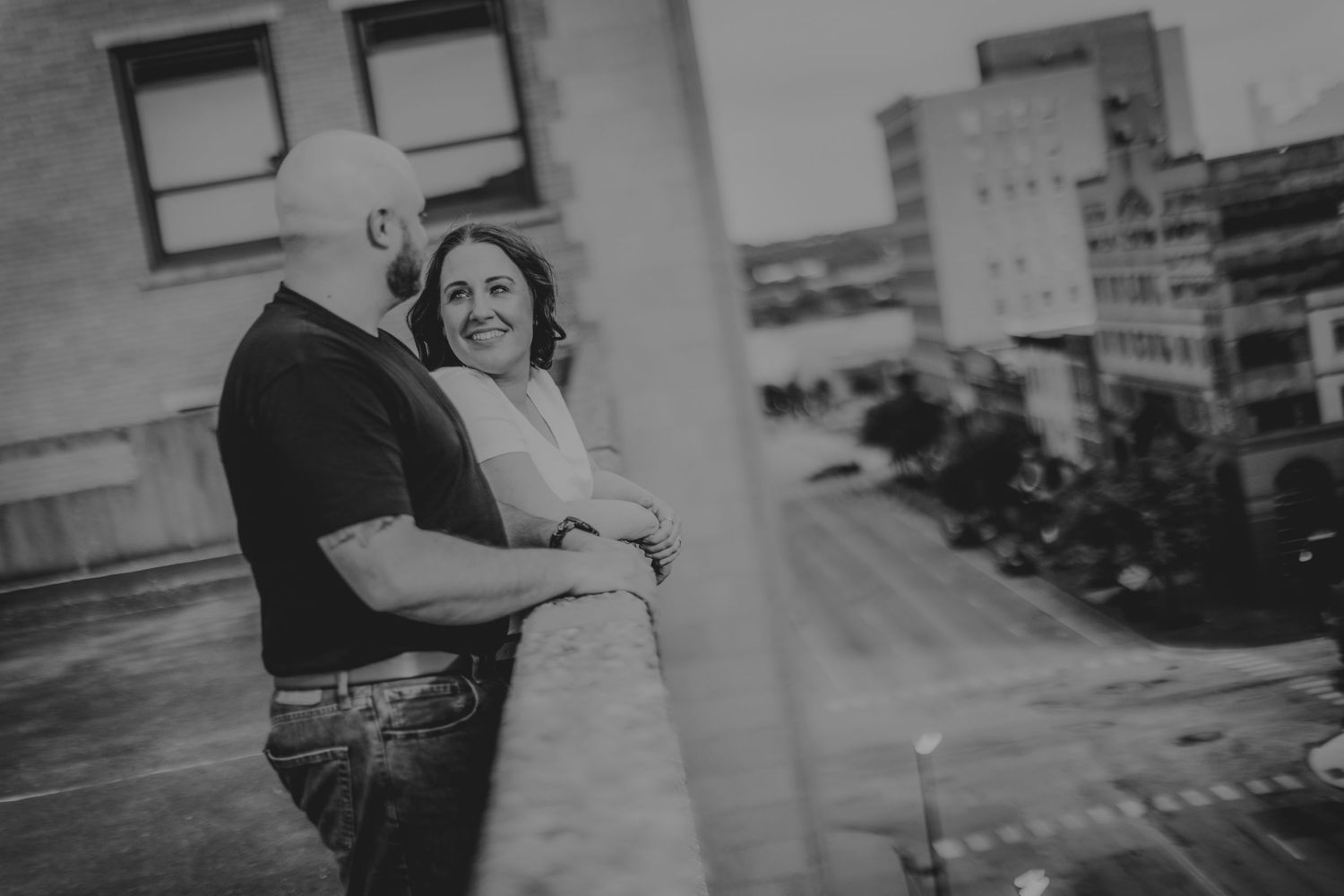 Black and white portrait of a couple in an urban setting.