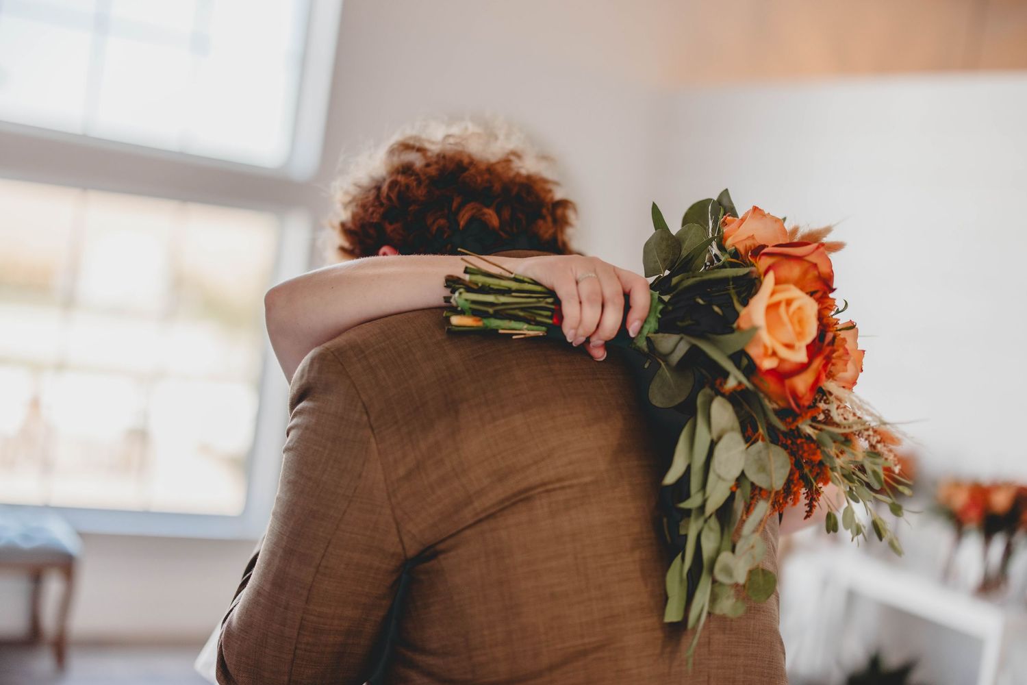 Wedding celebration featuring brown and orange color scheme in bright indoor setting.