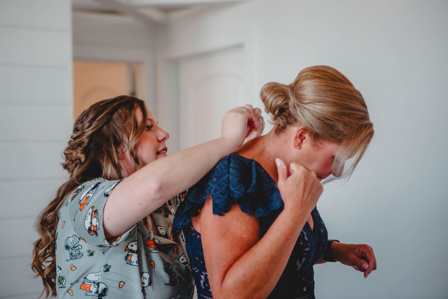 A touching moment between friends during preparations.